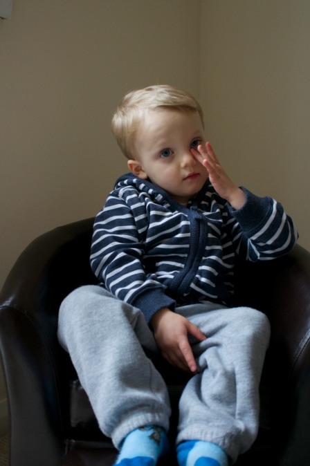 Callum in his armchair, using only the available light.