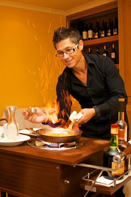 Our waiter preparing flambéed crepes for dessert.
